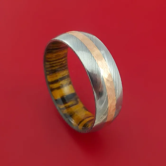 Lashbrook Damascus Steel Ring with 14k Rose Gold Inlay and Interior Hardwood Sleeve Custom Made Band Rings Lashbrook Damascus Steel Ring with 14k Rose Gold Inlay and Interior Hardwood Sleeve Custom Made Band Rings